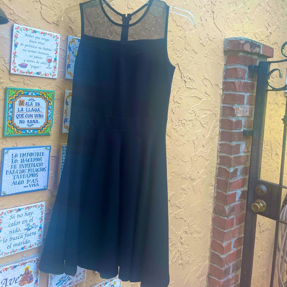 Classy short A-line shaped evening or cocktail dress with round mesh neck.